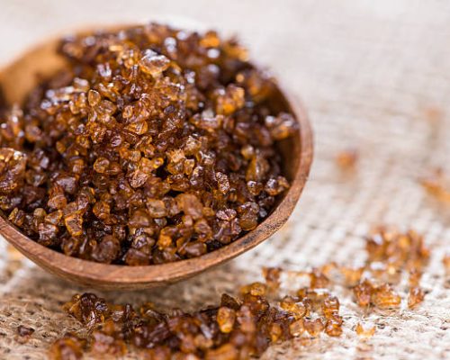 Heap of Smoked Salt on rustic wooden background